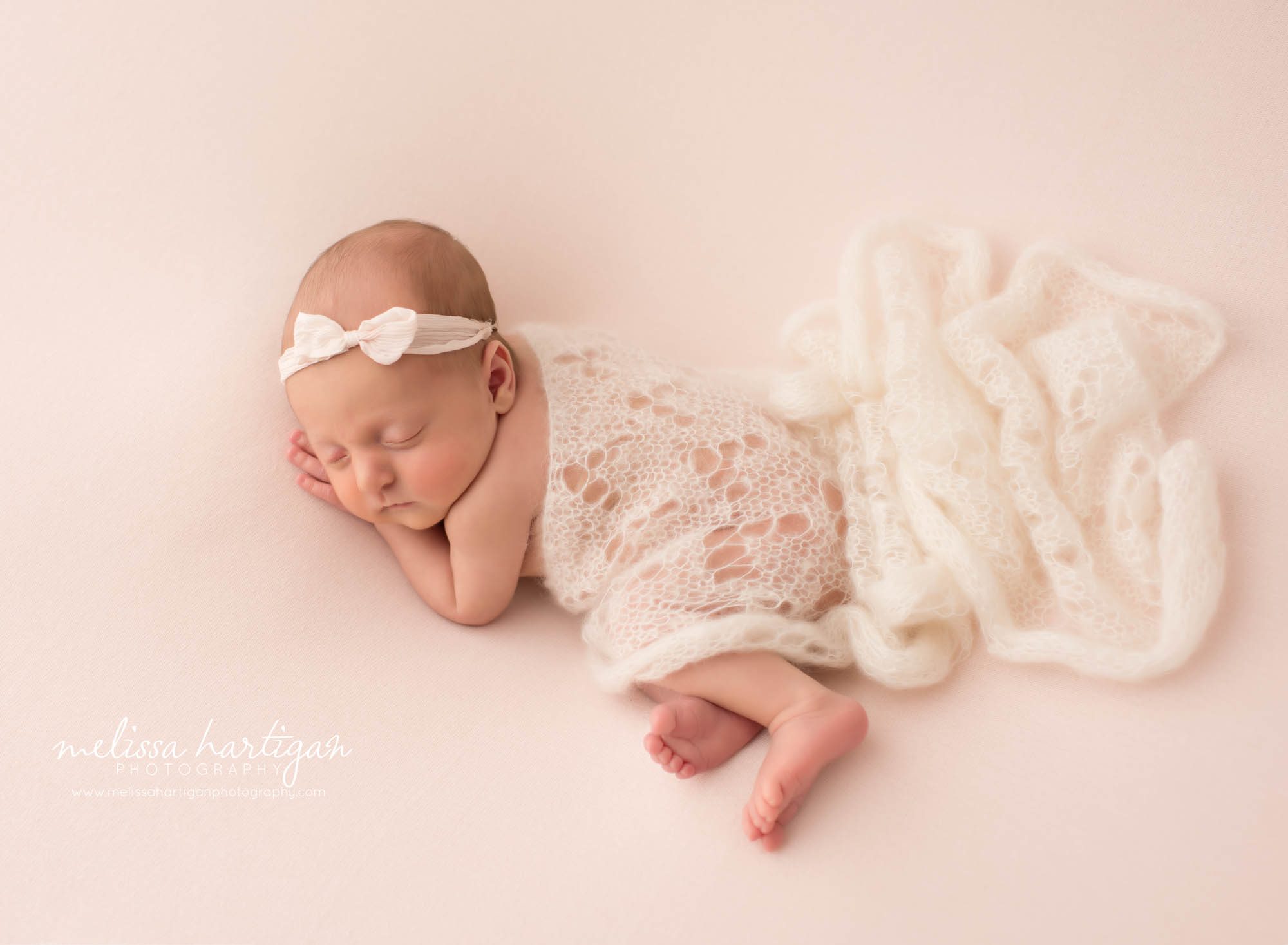 newborn baby girl pose don side with knit lace layer draped over her Newborn Photography Manchester CT
