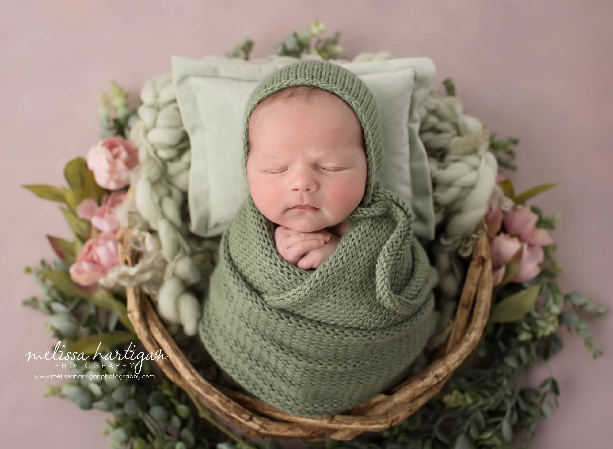 Baby girl swaddled in green wrap wearing green knitted bonnet Chaplin CT Newborn Photography
