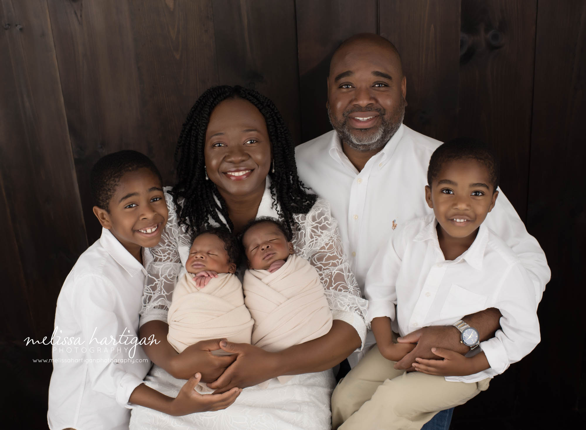 Family posed together mom dad two big brothers and twin boys