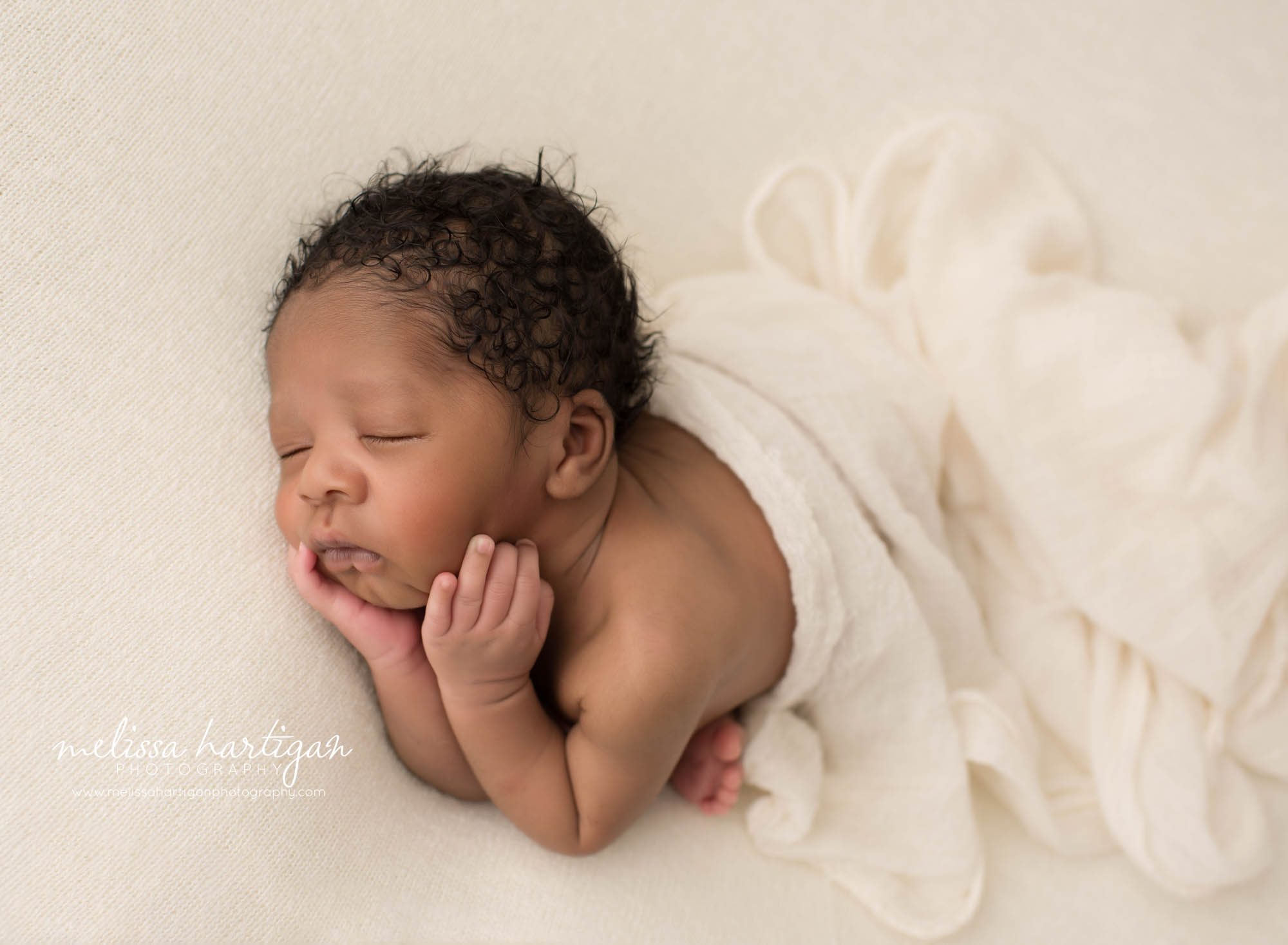 newborn baby boy posed on side
