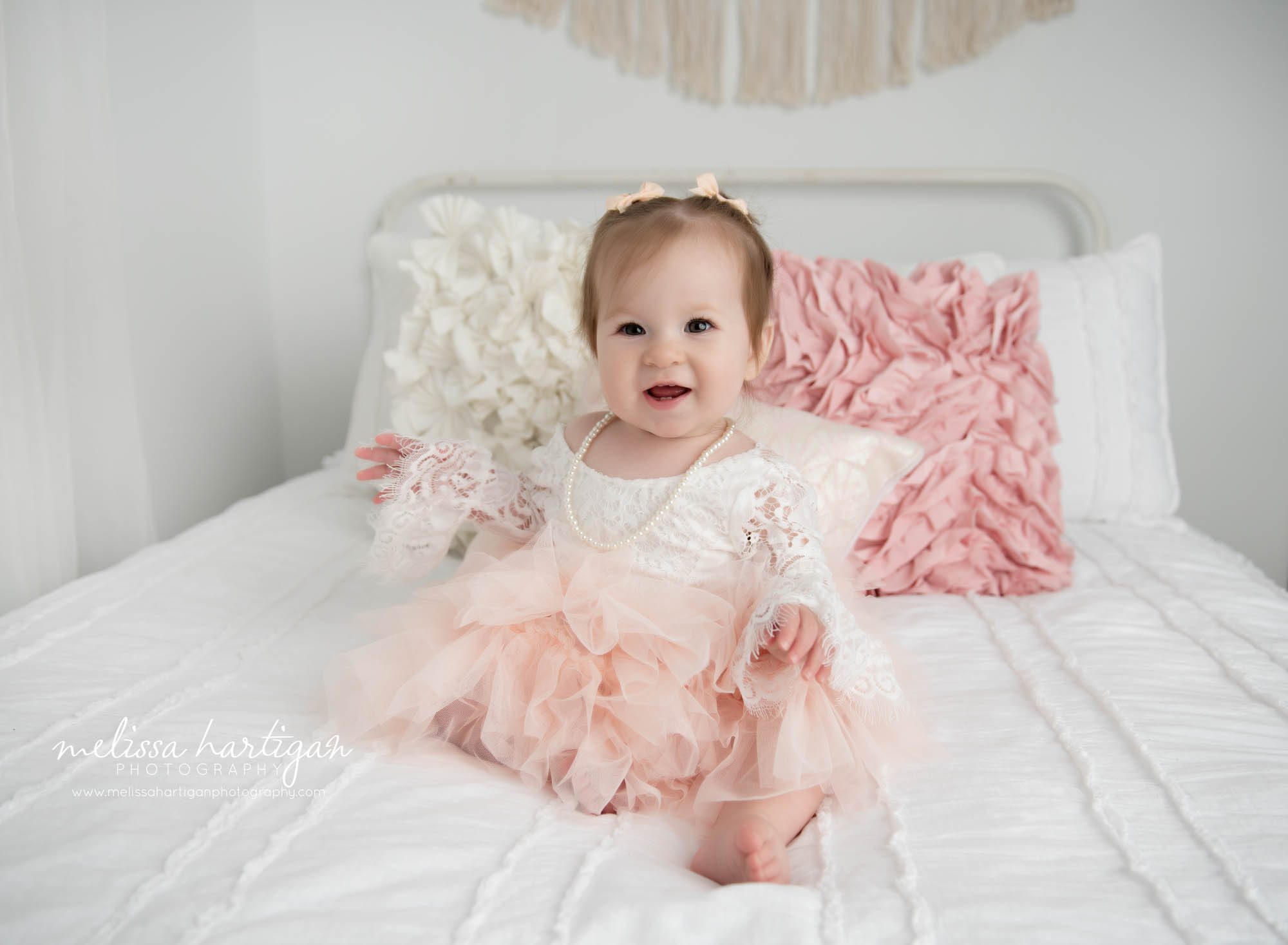 Baby girl wearing cream and pink lace dress for one year milestone photoshoot Preston CT Baby Photography