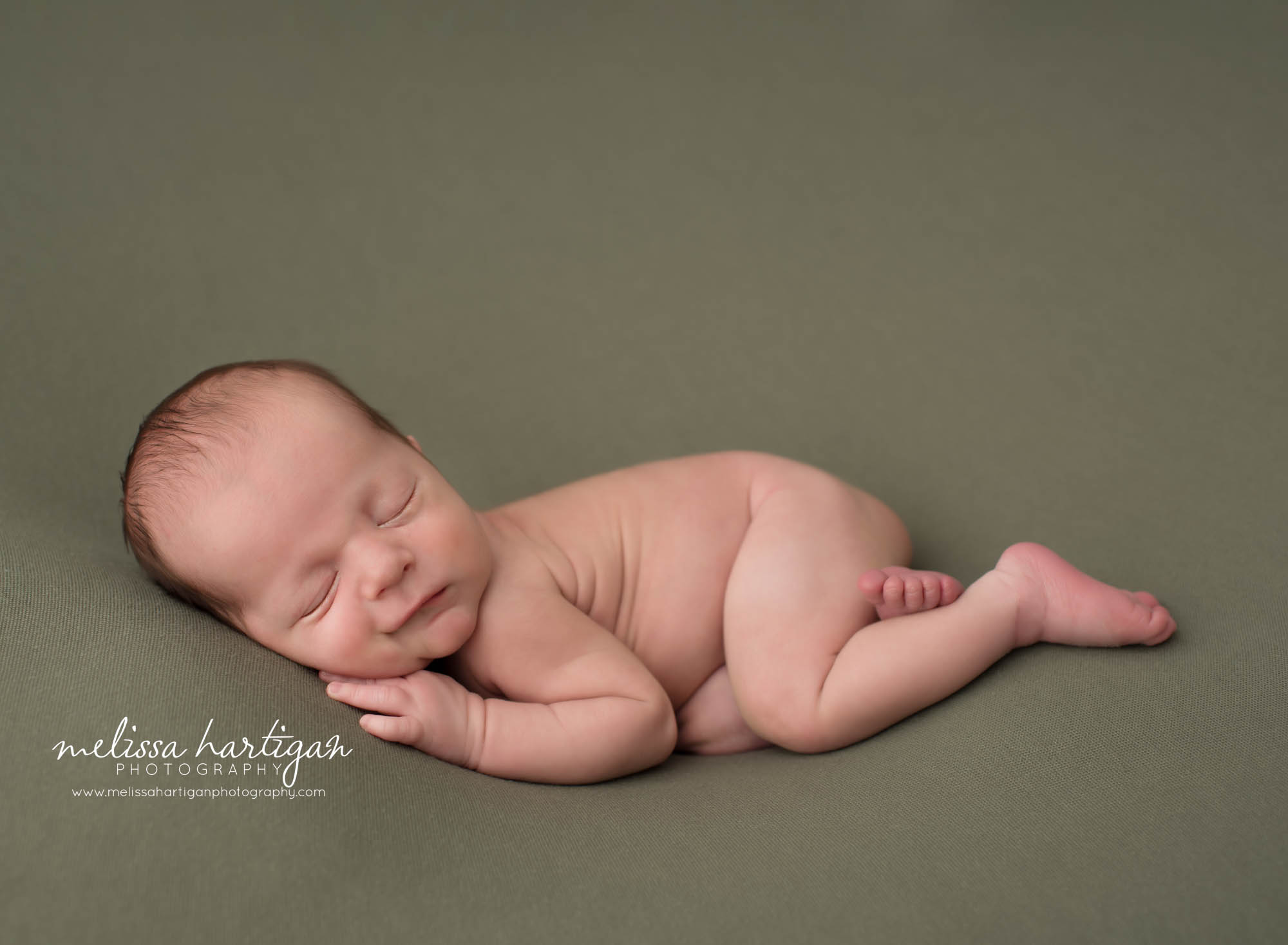 Newborn baby boy posed on green backdrop Collinsville CT Newborn Photography