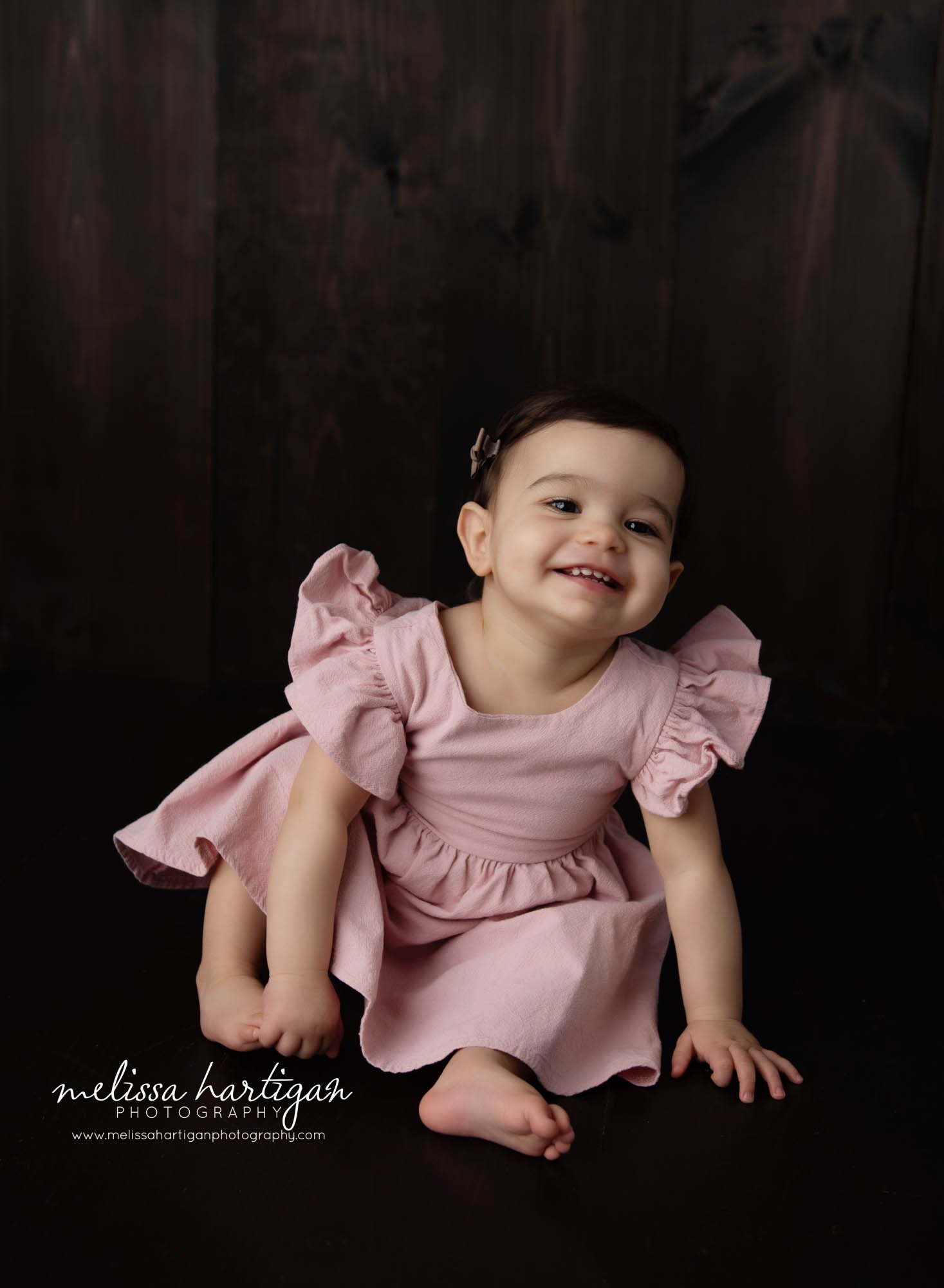 Baby girl happy smiling wearing pink dress holding foot Baby Photography Bloomfield CT