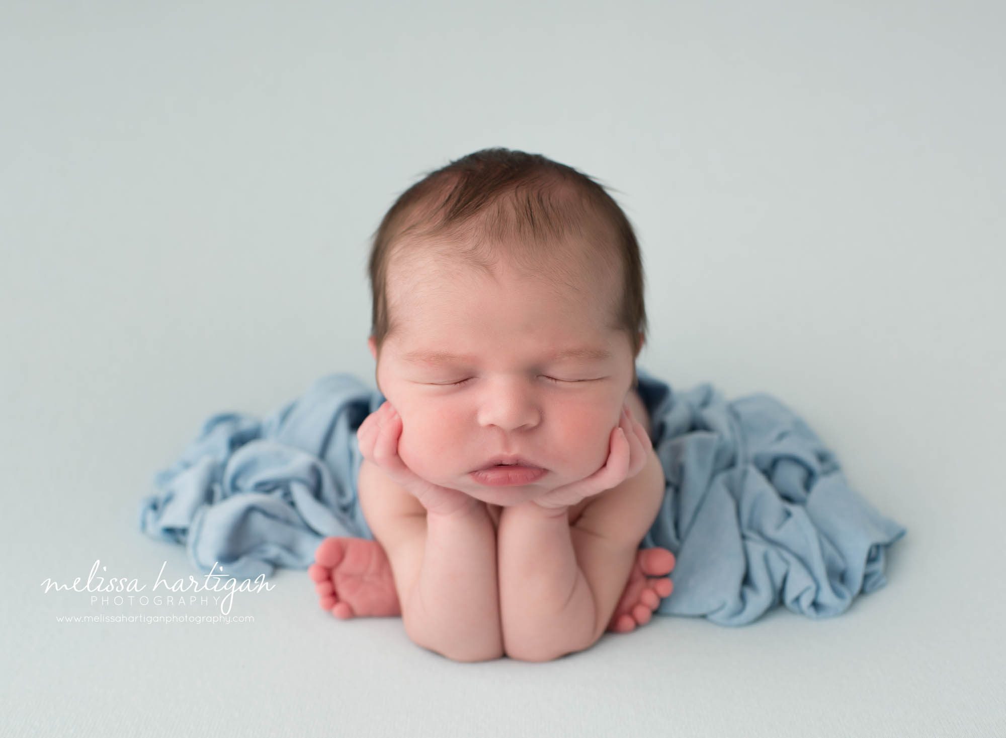 Newborn baby boy posed froggy pose
