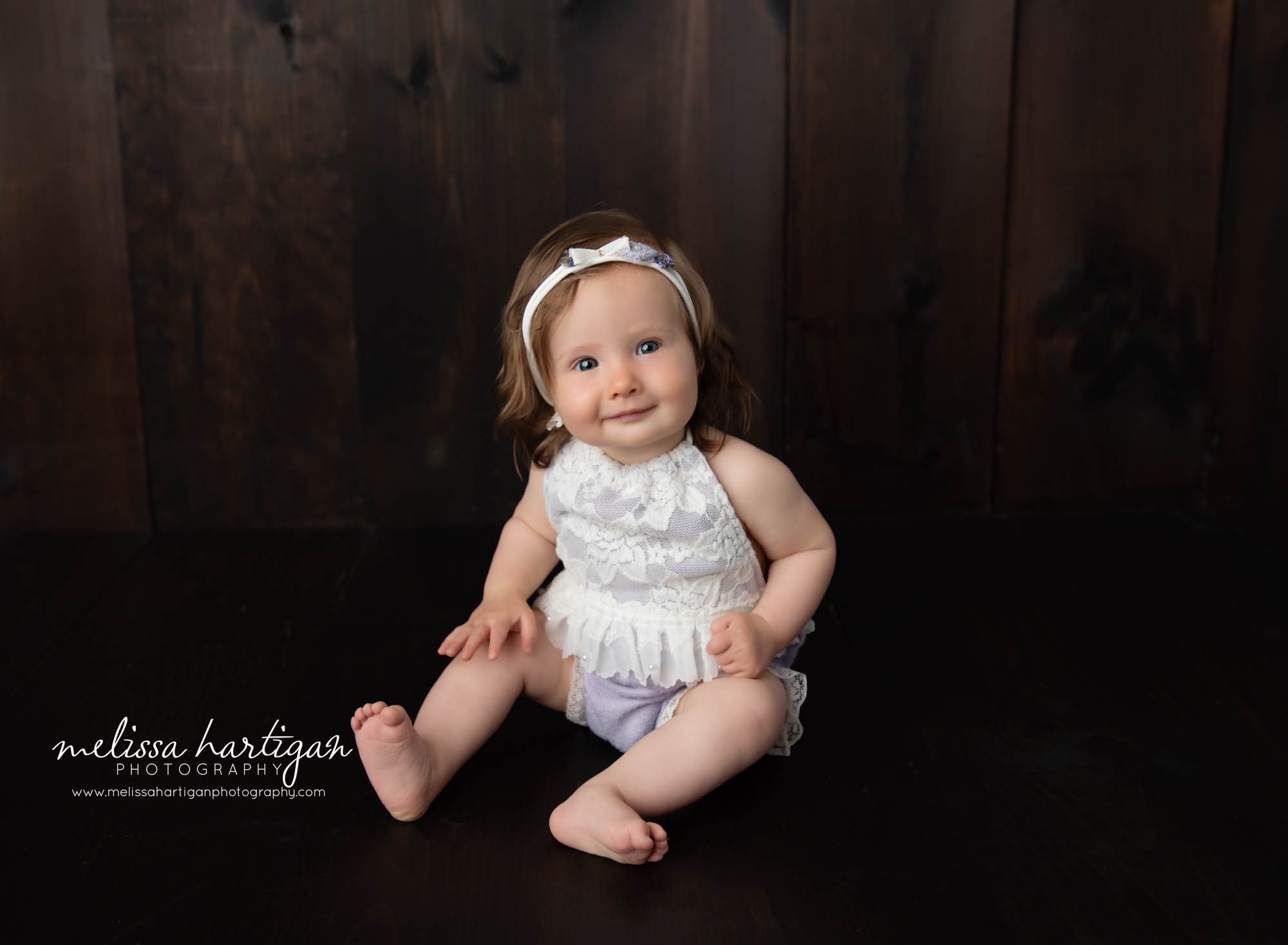 Baby girl wearing cream lace and purple outfit for milestone session in Tolland CT Baby Photographer