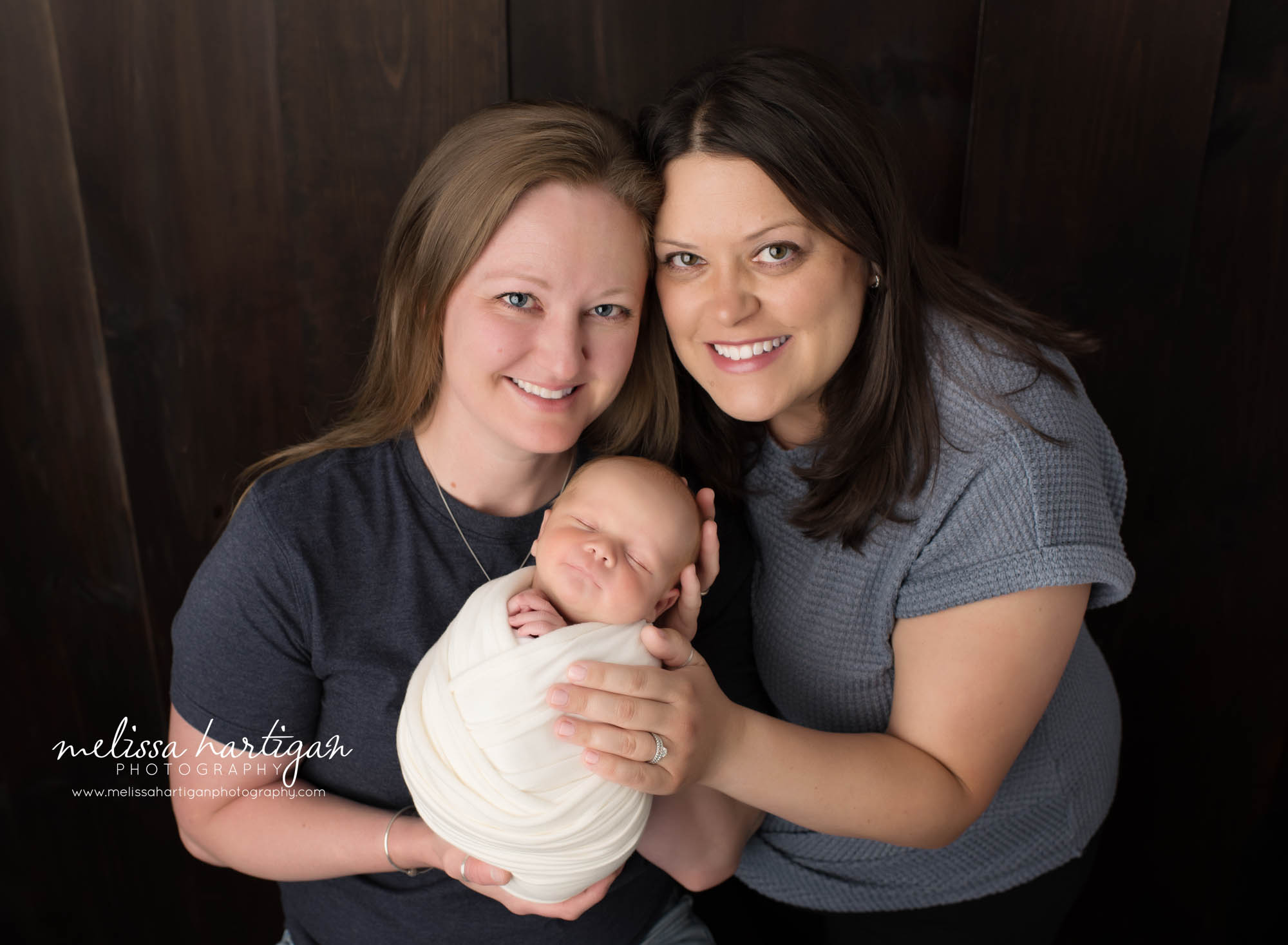 Couple holding their newborn son