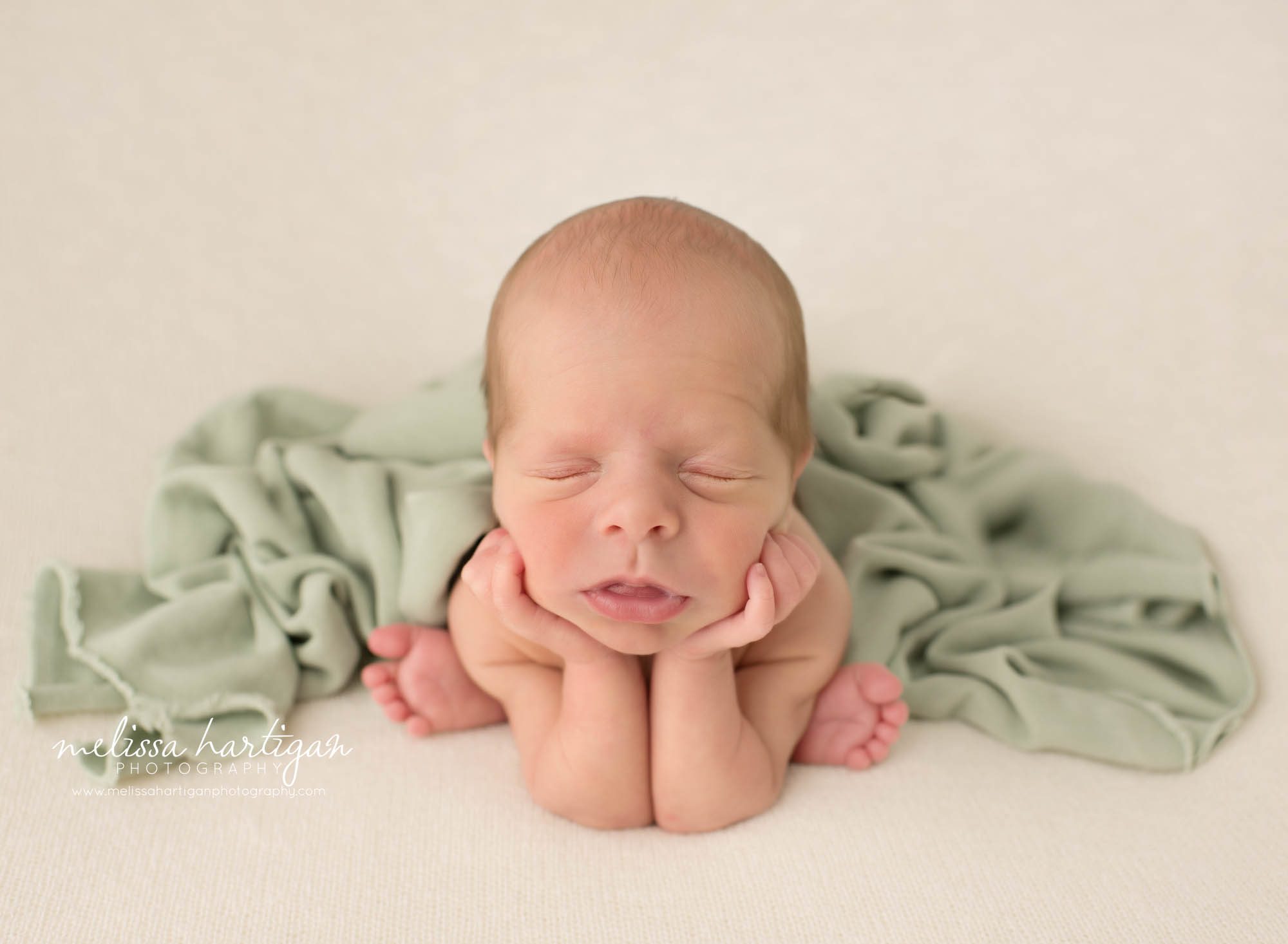 Newborn baby boy posed froggy pose with green layer Colchester CT Newborn Photography