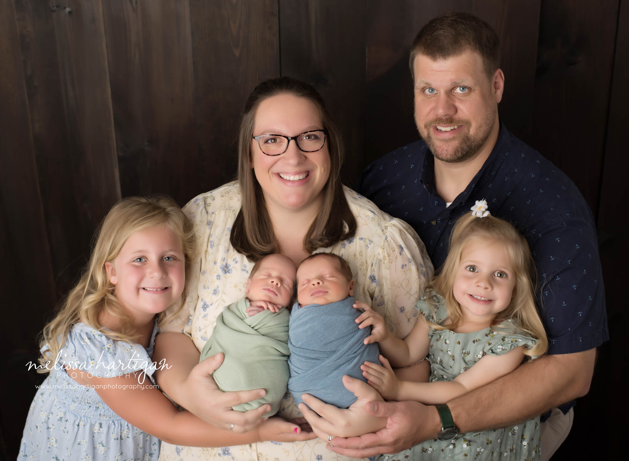 Mom dad big sisters and twin boys posed together for family pose Colchester CT Newborn Photography