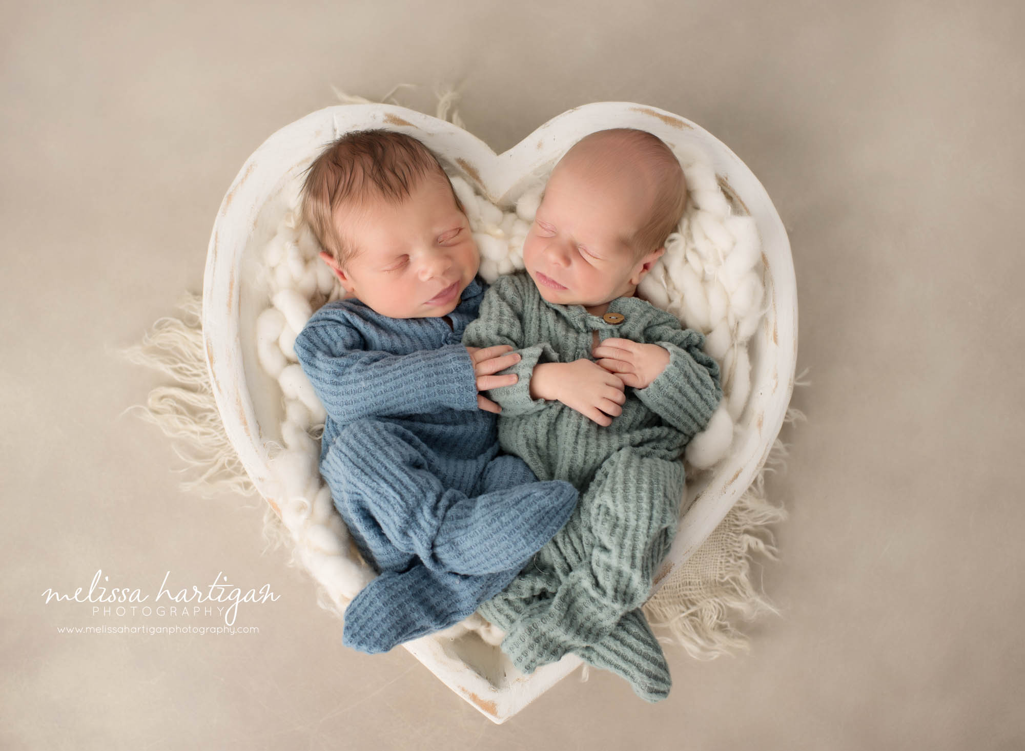 Twin boys posed together in white wooden heart prop Colchester CT Newborn Photography