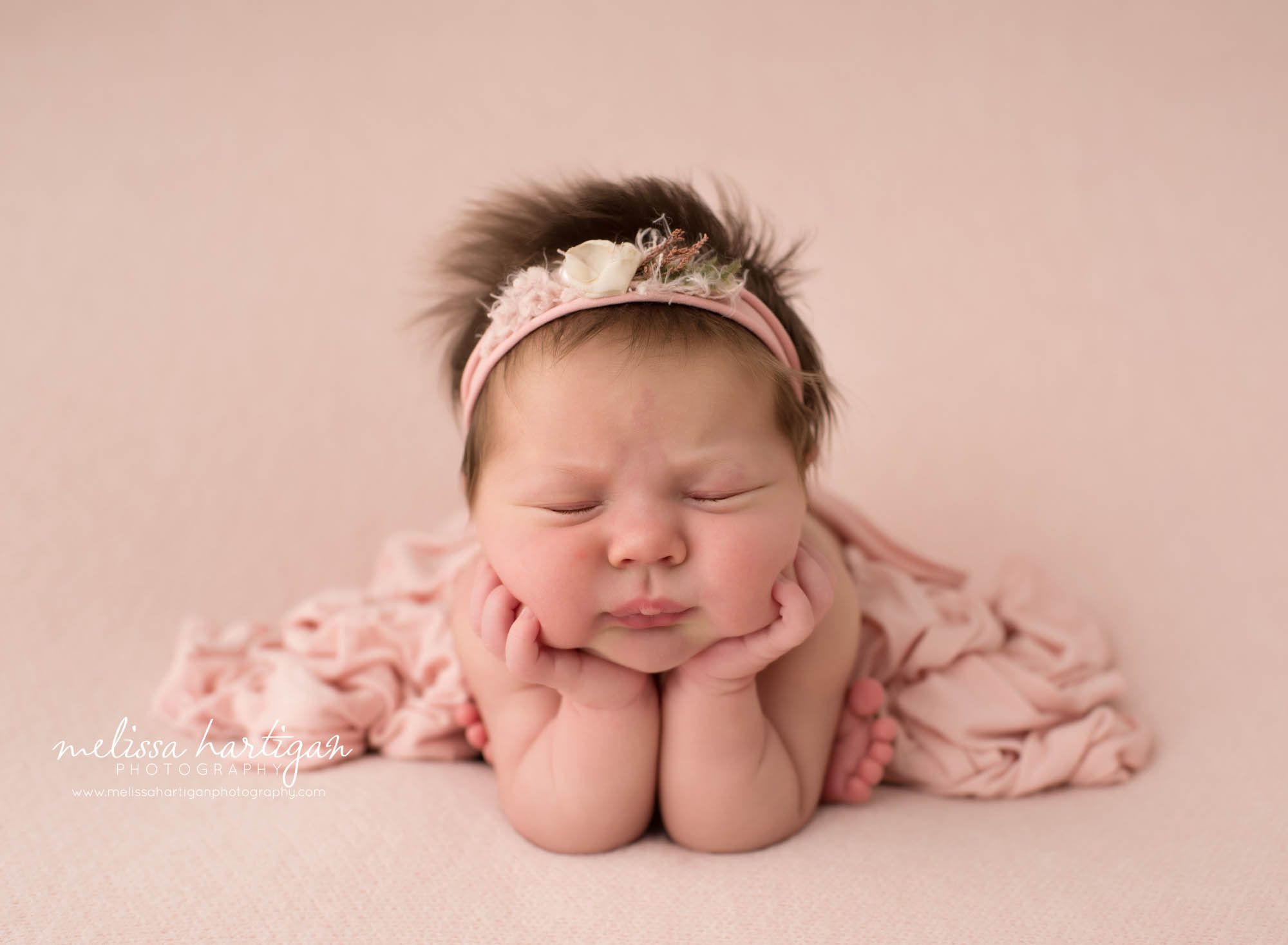 Newborn baby girl posed froggy pose
