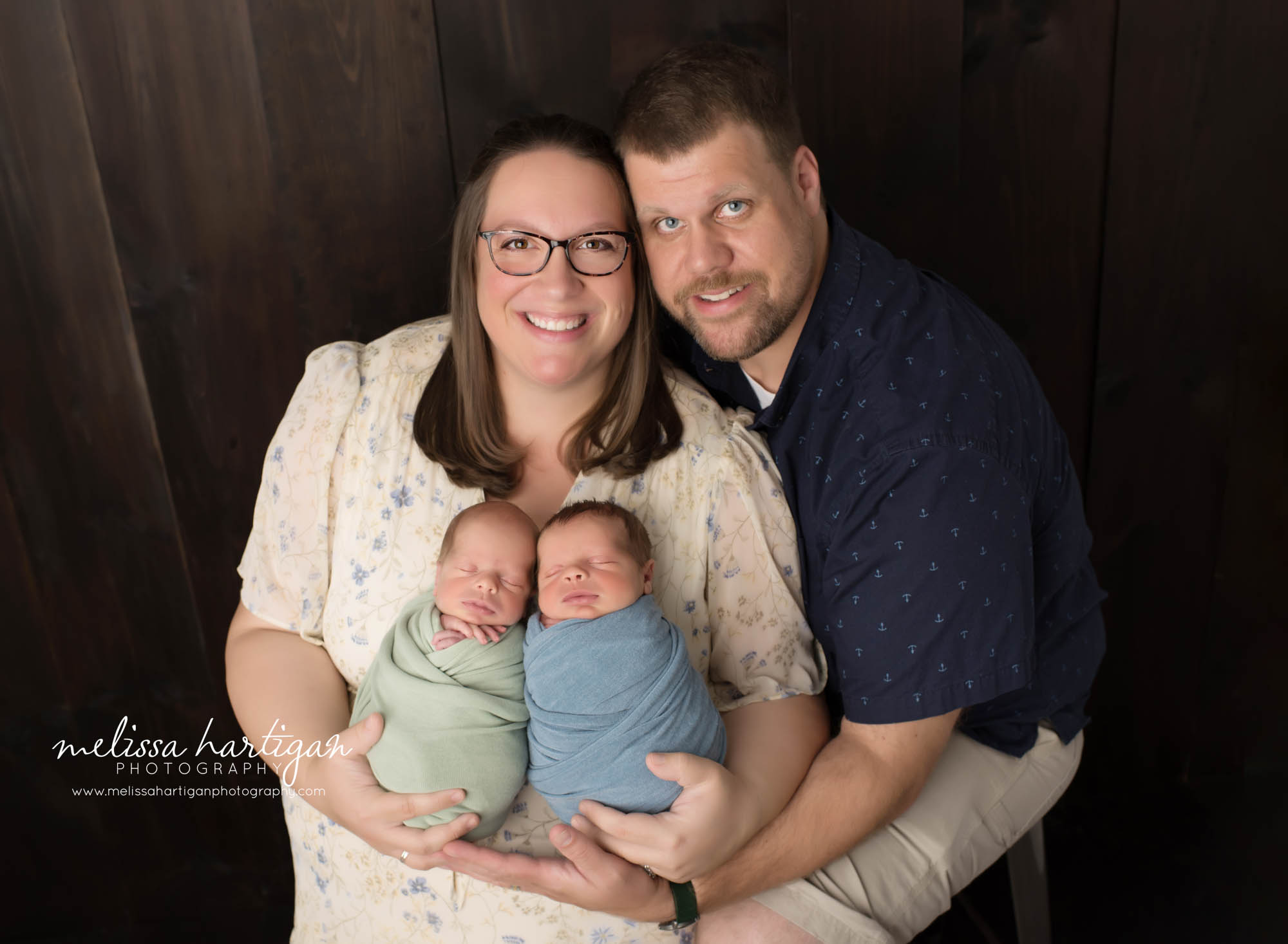 Mom and dad posed with twin boys for parents pose