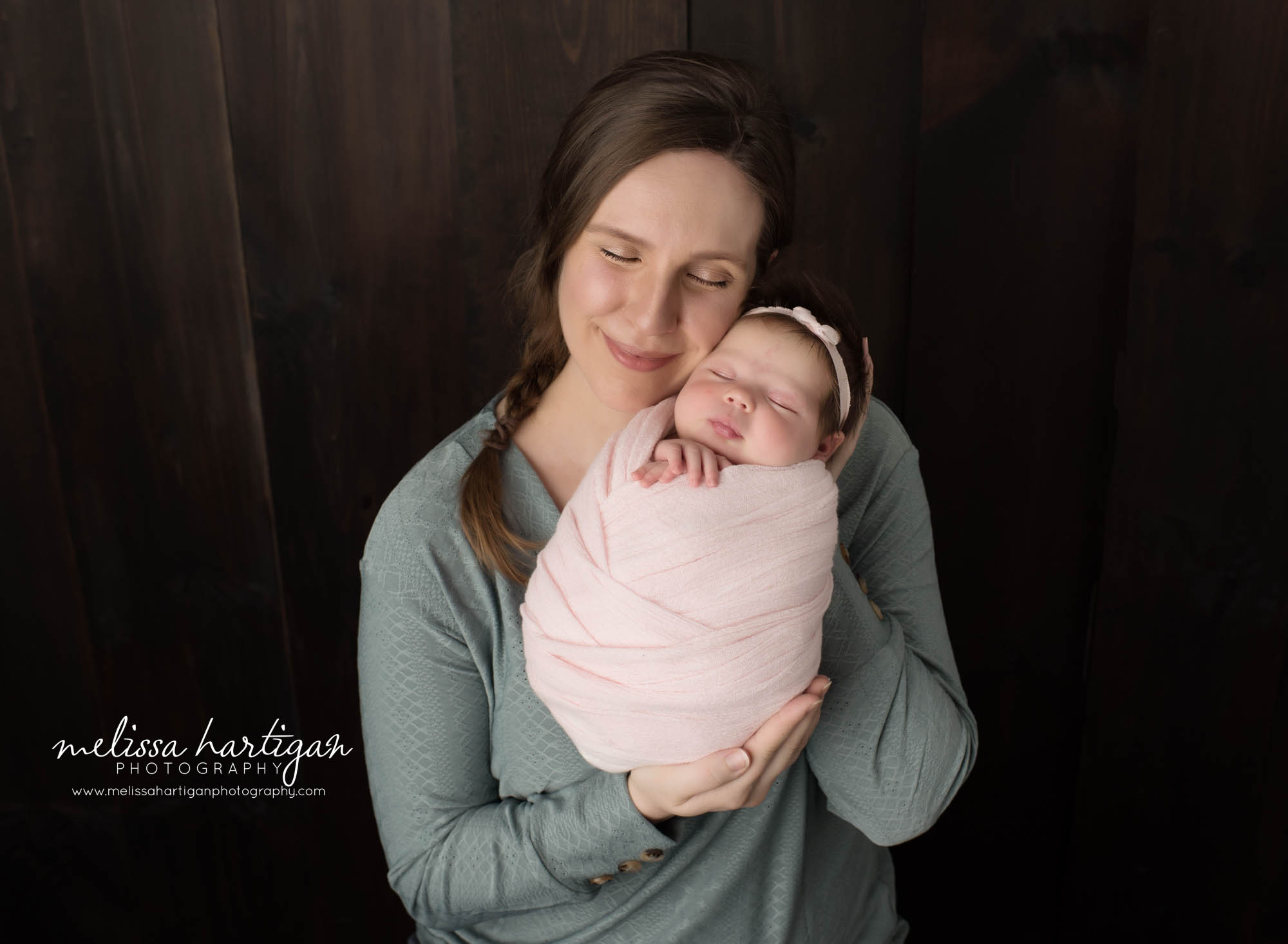 Mom holding newborn daughter in parents pose