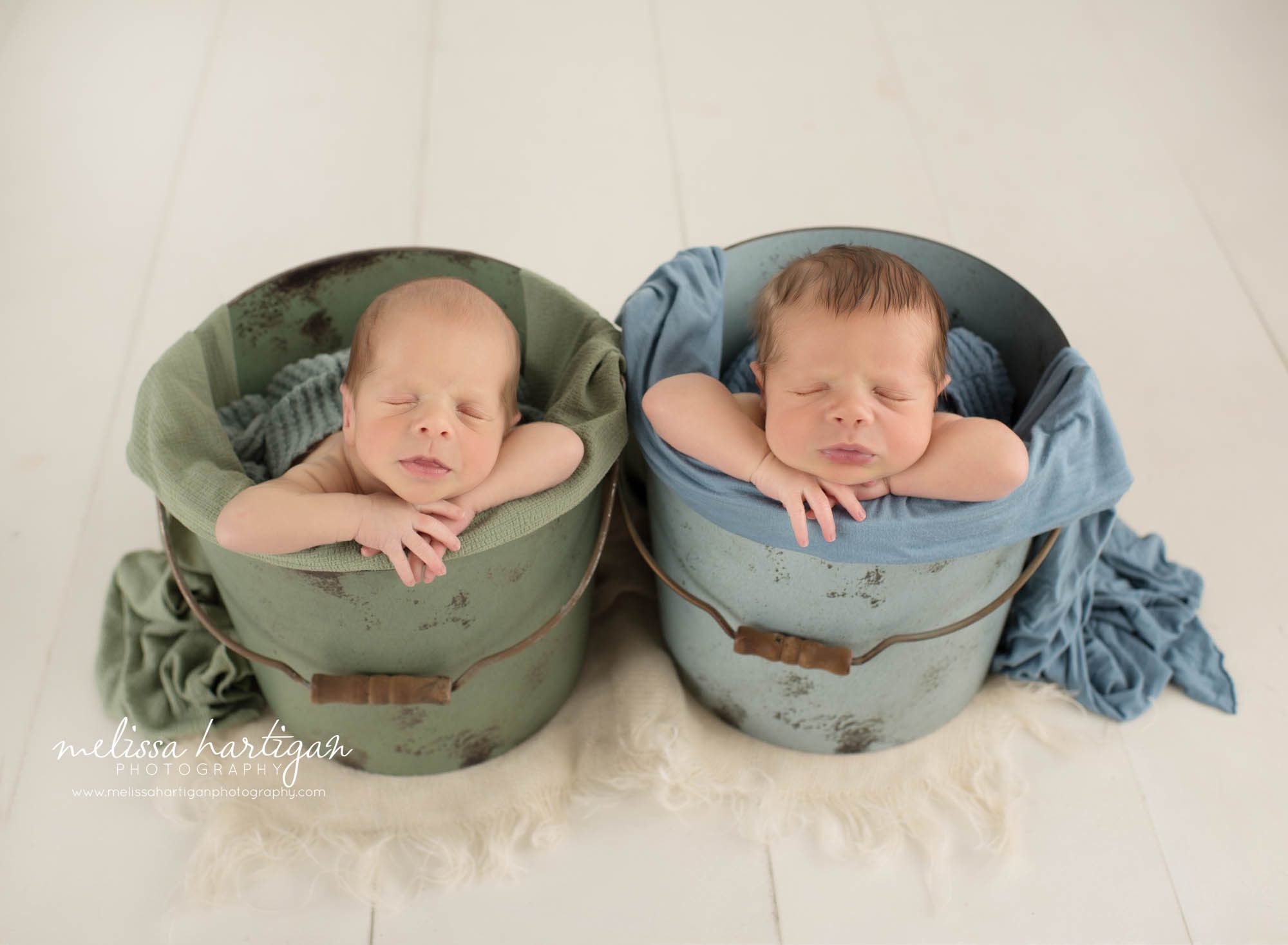 Twin boys posed in buckets with blue and green colors Colchester CT Newborn Photography