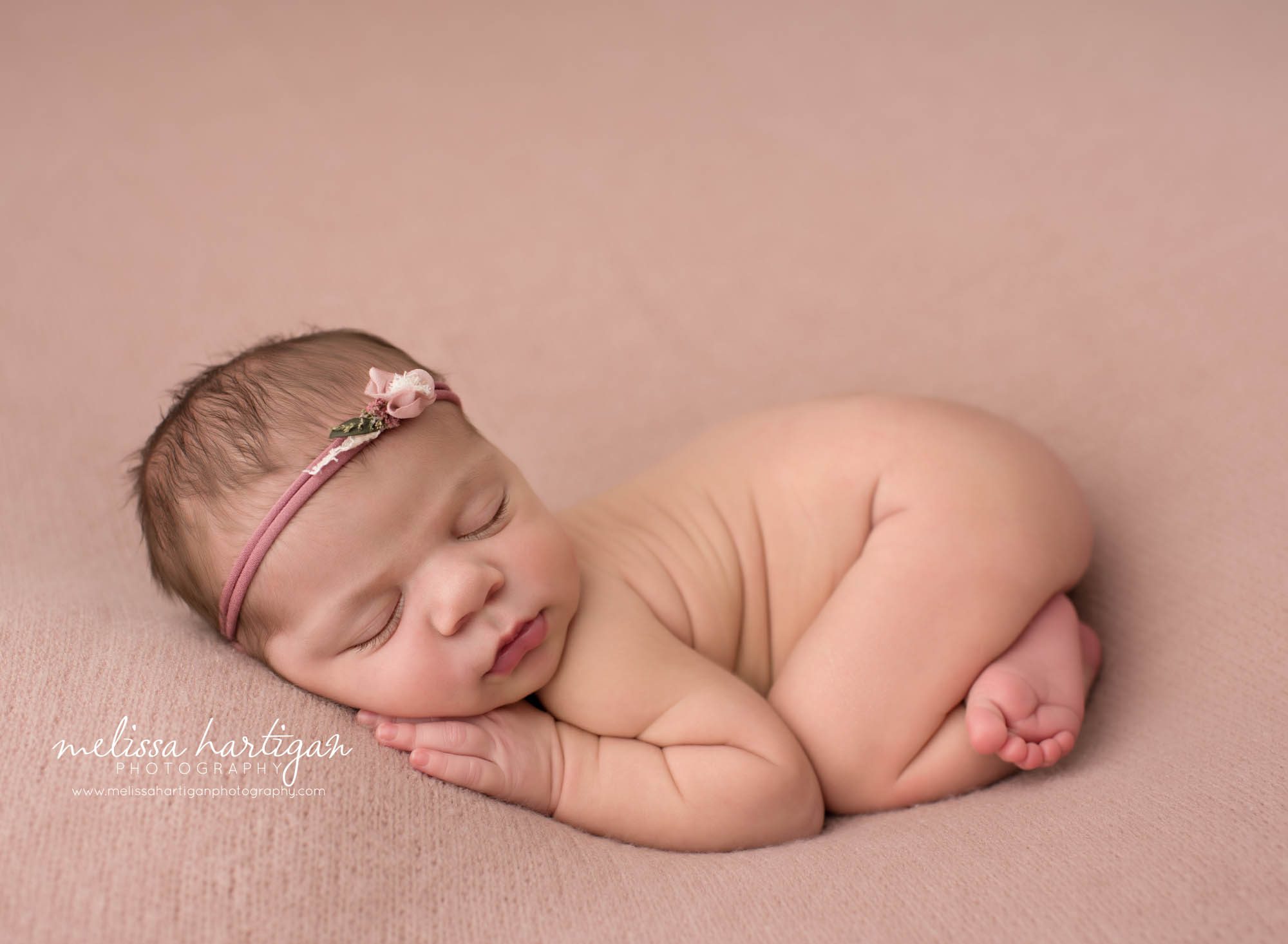 Newborn baby girl posed bum up pose