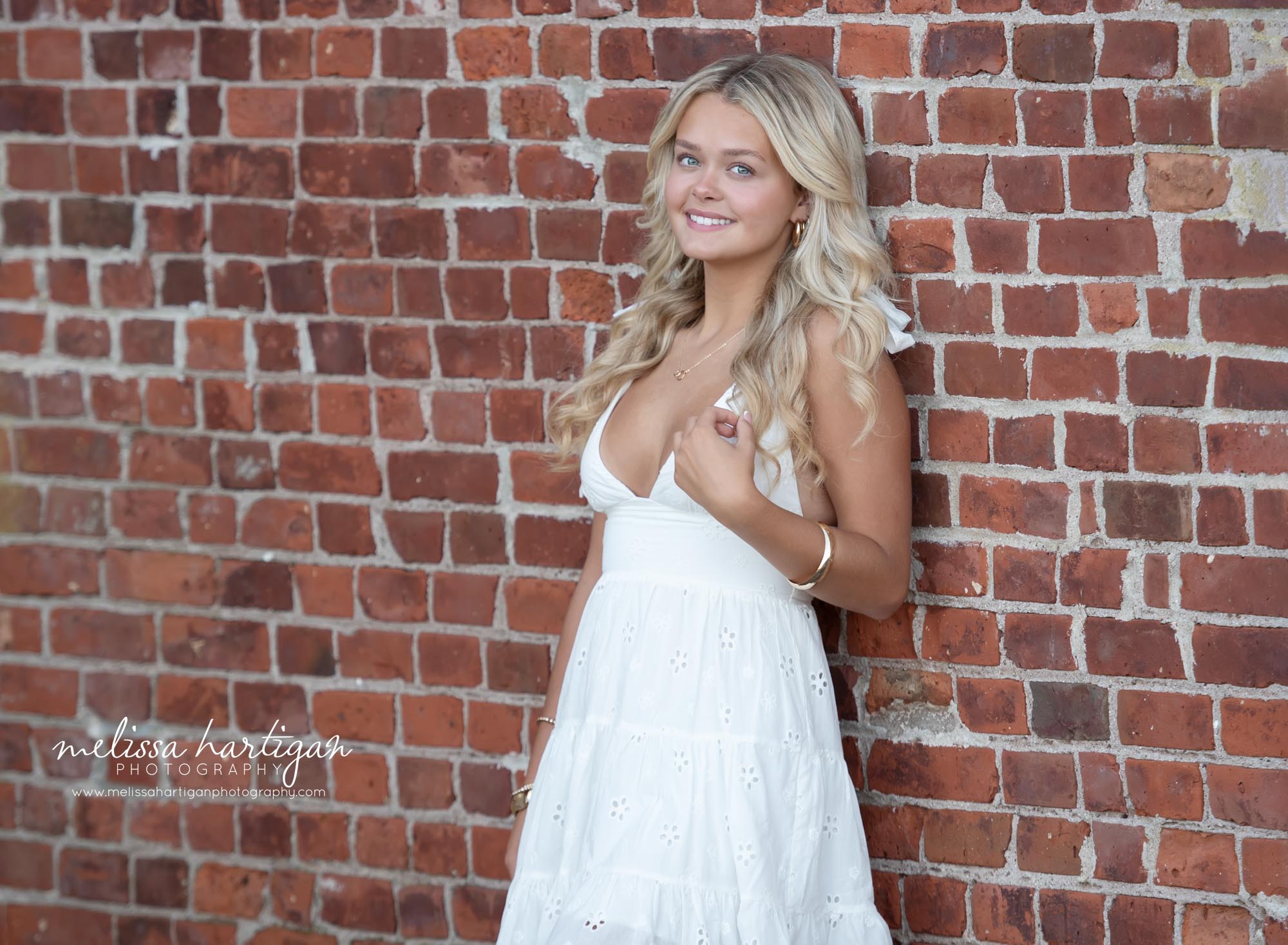 High school senior leaning against brick wall Coventry CT Senior Photography