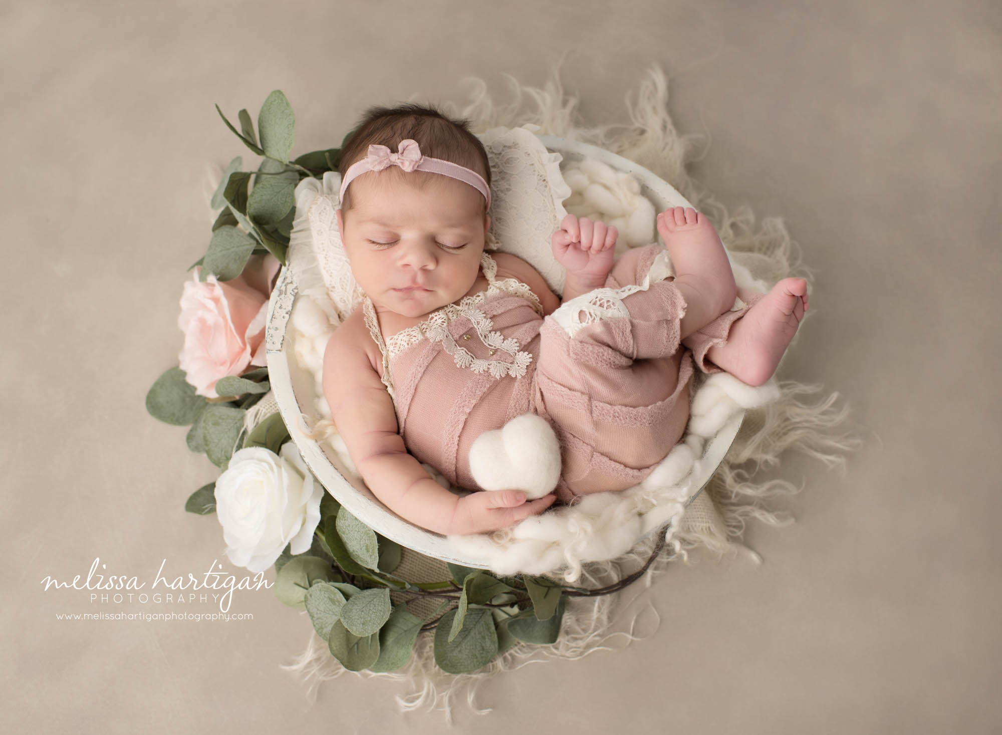 Newborn baby girl wearing pink baby girl outfit posed in wooden bow holding felted heart prop Newborn Photography Norwich CT