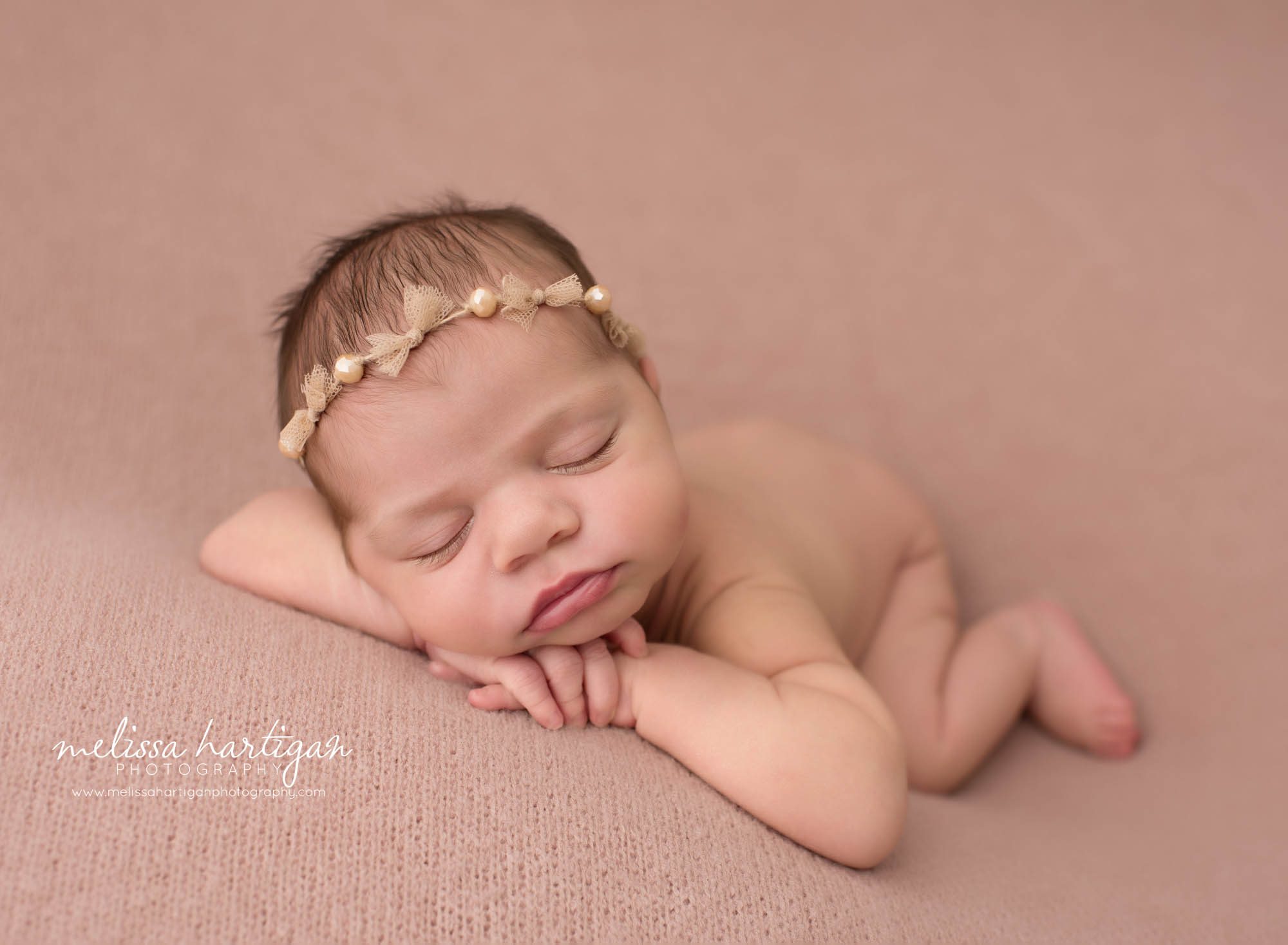 Newborn baby girl posed on pink backdrop Newborn Photography Norwich CT