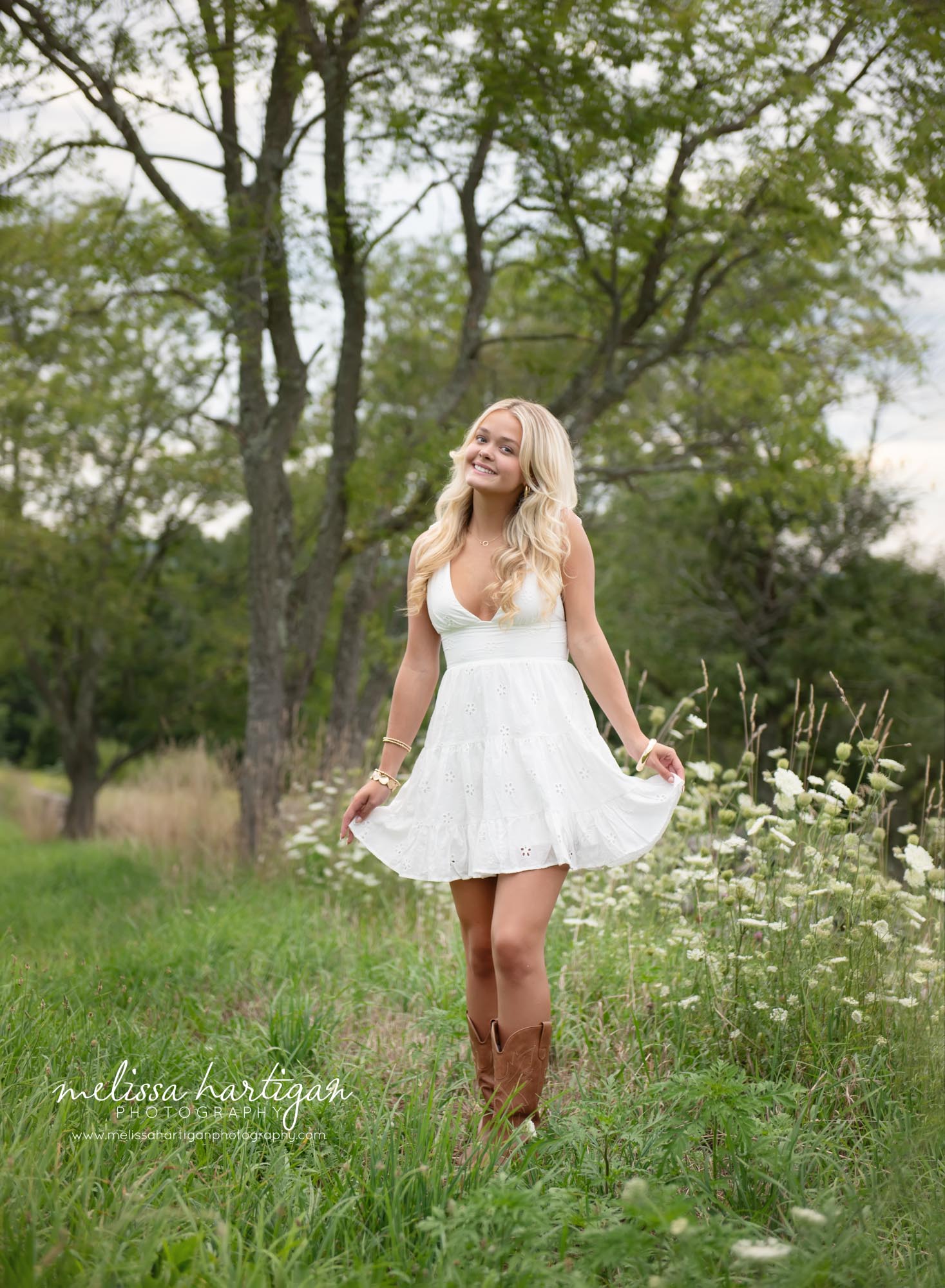 Girl happy smiling playing with sides of her dress