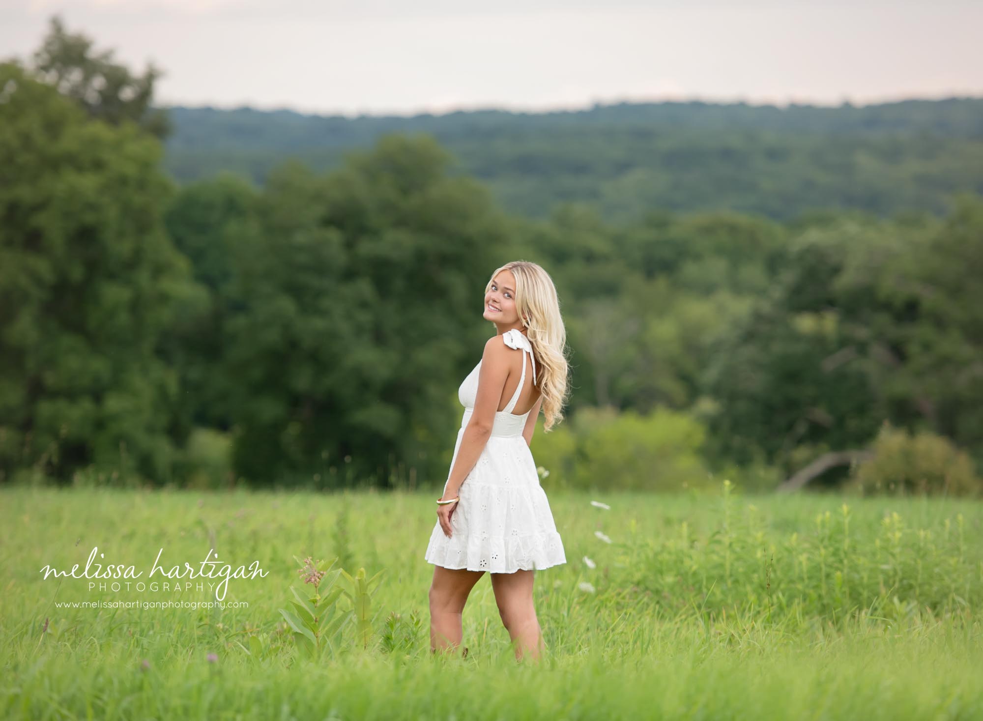 High school senior posing looking at camera smiling