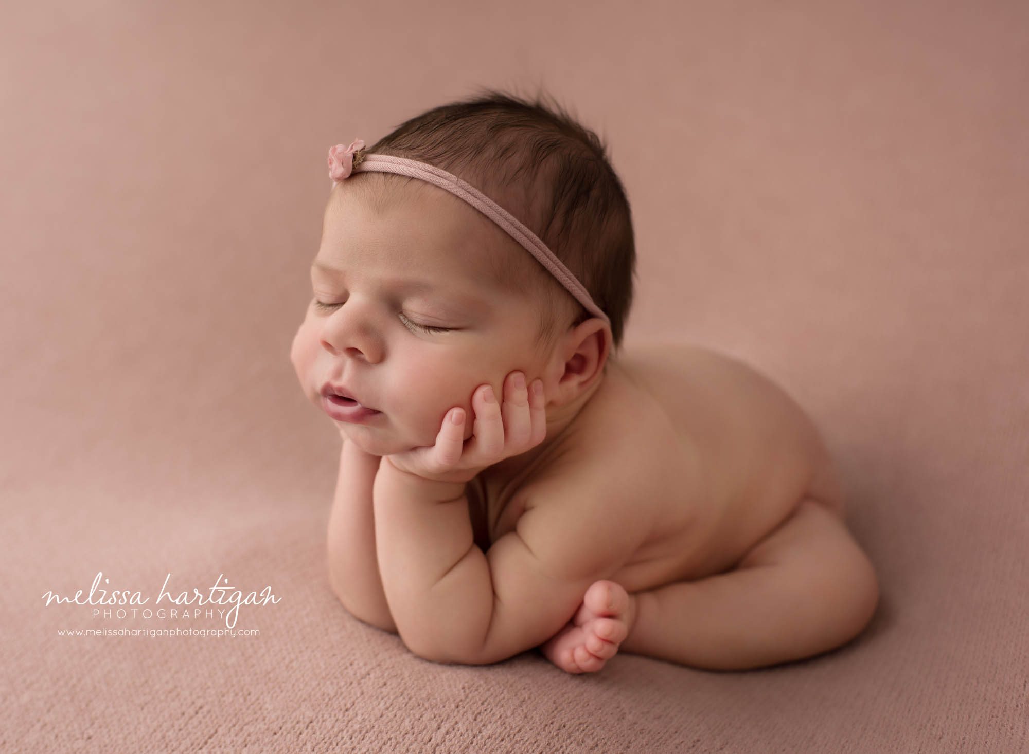 Newborn baby girl posed froggy pose