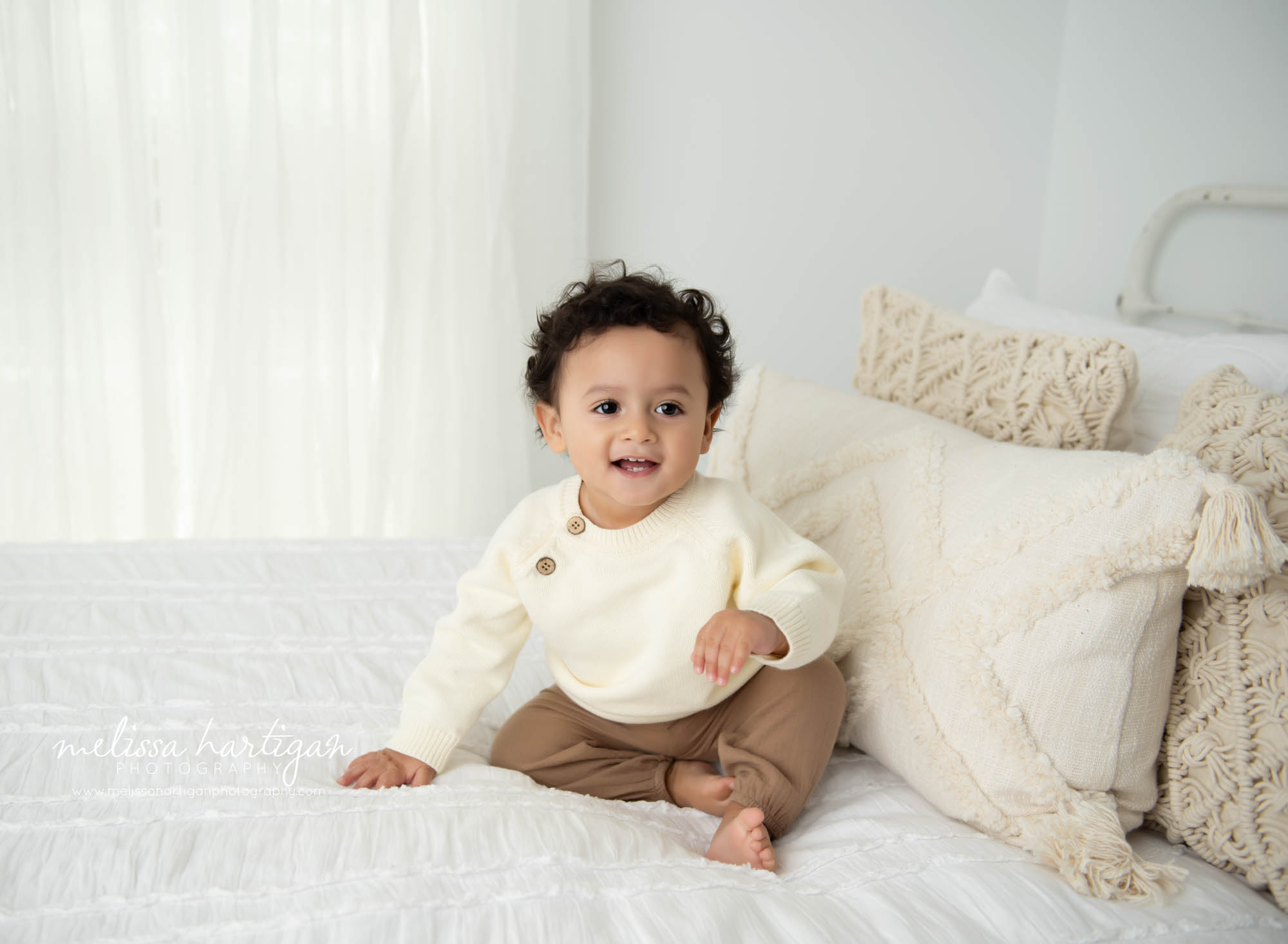 Baby boy sitting on bed in studio for milestone session Newington CT Baby Photography