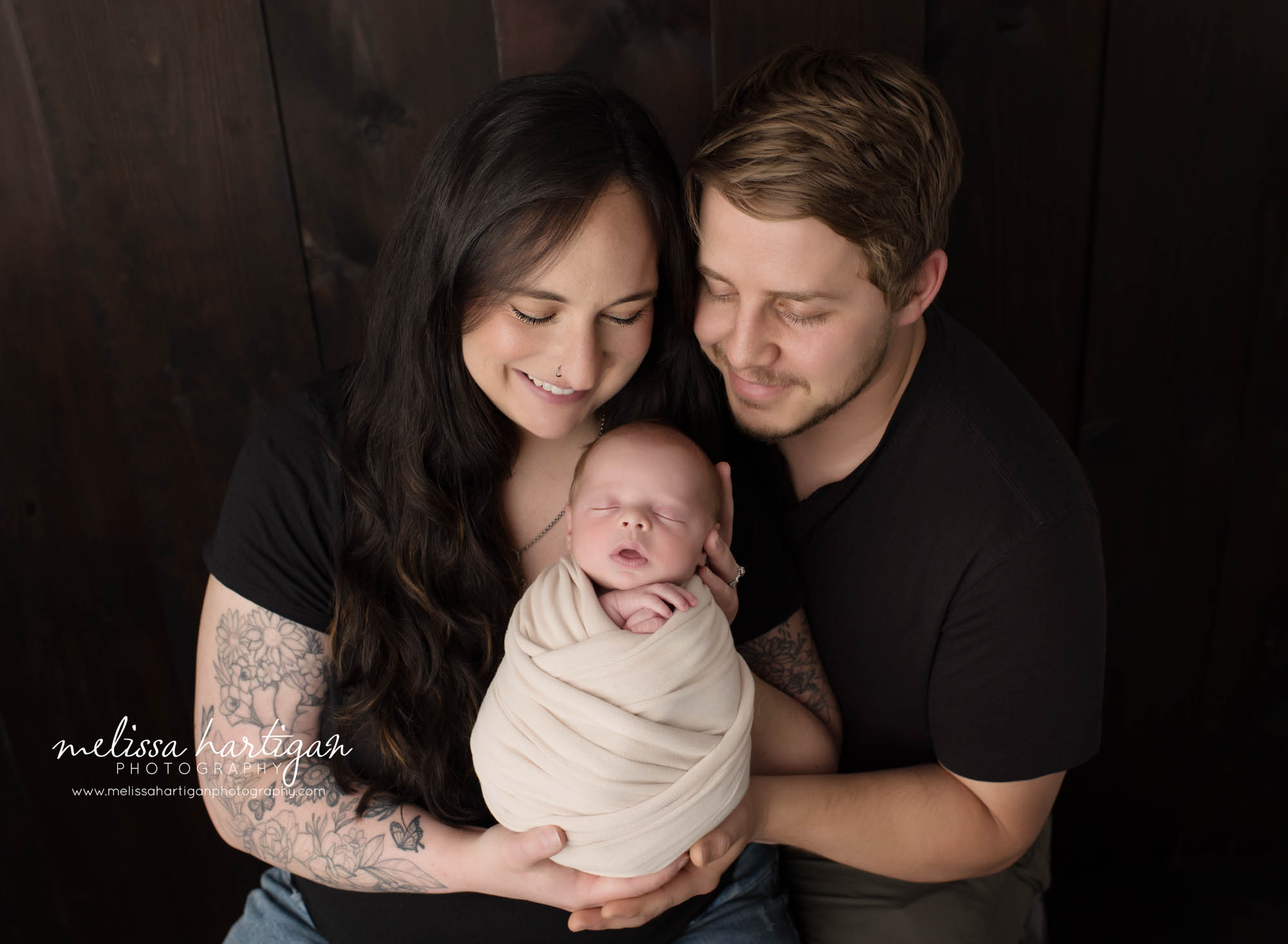Mom dad holding newborn son swaddled in cream wrap Columbia CT Newborn Photography